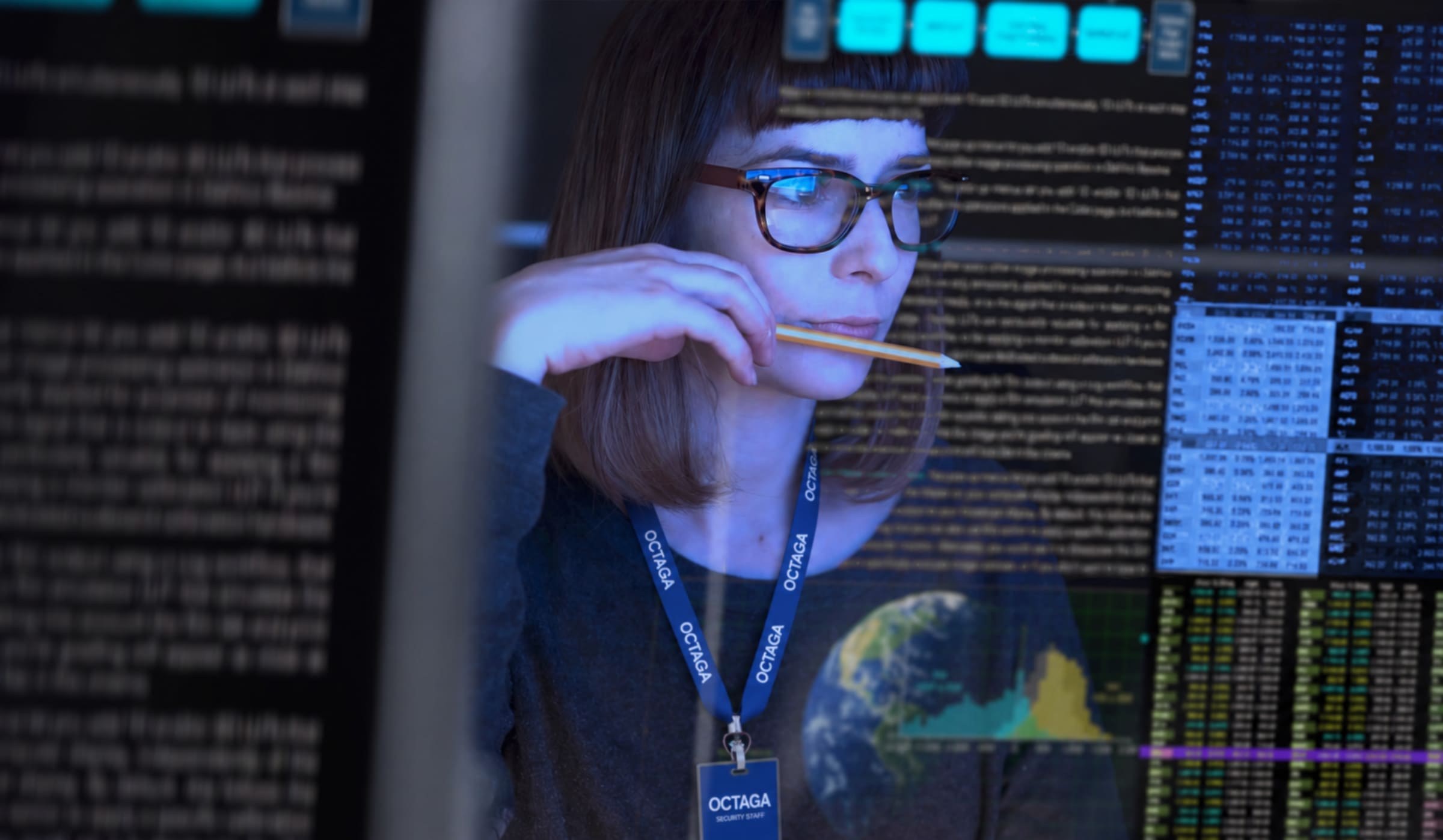 Octaga investigations analyst reviewing intelligence and data across multiple screens